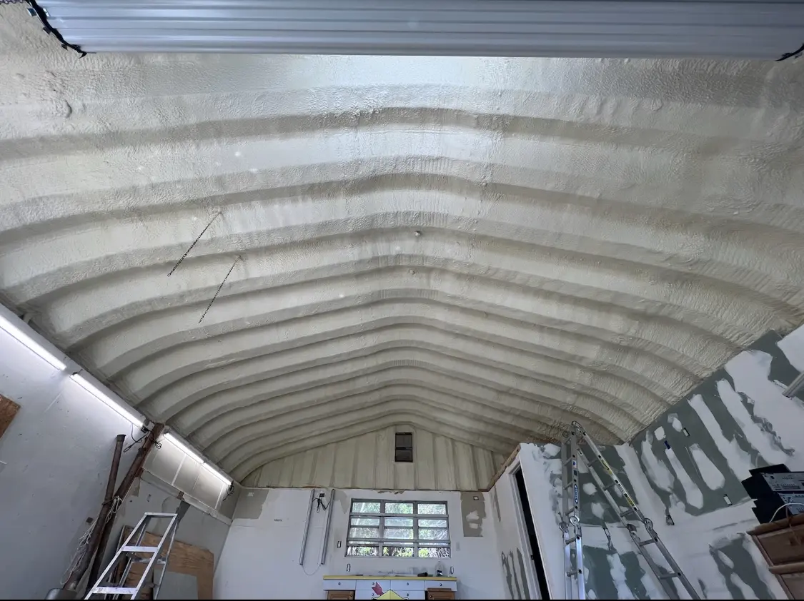 Spray polyurethane foam applied to the underside of a metal roof deck in La Follette